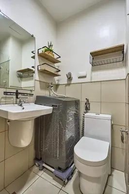 a bathroom with a toilet and a sink and a mirror at Y&N Staycation Cozy and Aesthetic Unit near to NAIA Airport in Manila