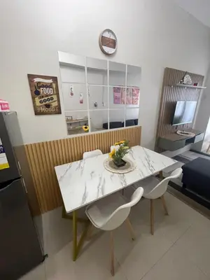 a dining room with a white table and chairs at Y&N Staycation Cozy and Aesthetic Unit near to NAIA Airport in Manila