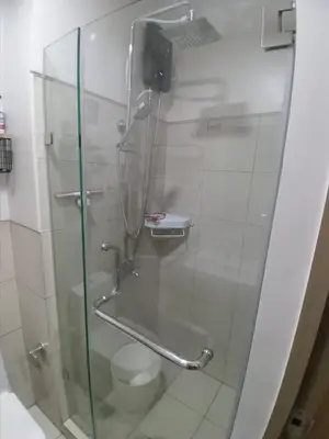 a bathroom with a glass shower with a toilet at Y&N Staycation Cozy and Aesthetic Unit near to NAIA Airport in Manila