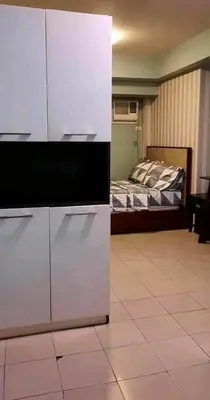 a room with a bedroom with a bed and a tv at Avida San lorenzo Tower 1 Studio in Manila