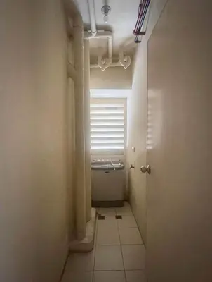 a small hallway with a window in a bathroom at Avida San lorenzo Tower 1 Studio in Manila