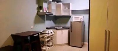 a small kitchen with a sink and a refrigerator at Avida San lorenzo Tower 1 Studio in Manila