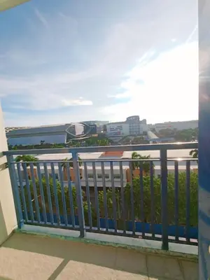 a balcony with a blue railing and a view of the ocean at Sea Residences Karen's Staycation in Manila