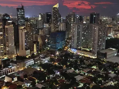 a view of a city at night at Christine Suites PH 1BR with Balcony Gramercy Residences Makati in Manila
