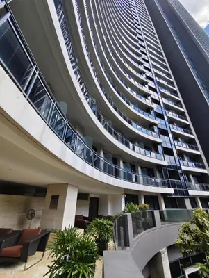 a tall building with a spiral staircase in front of it at Christine Suites PH 1BR with Balcony Gramercy Residences Makati in Manila