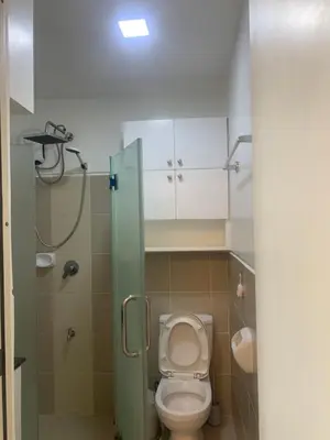 a small bathroom with a toilet and a shower at Smdc south Residences almanza uno in Manila