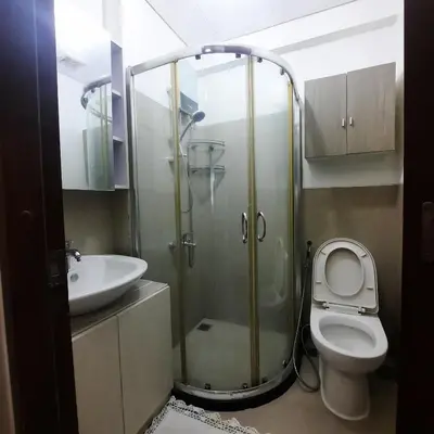 a bathroom with a shower and a toilet and a sink at ApartHotel Tower22307 in Manila