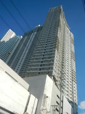 a tall building in front of a blue sky at ApartHotel Tower22307 in Manila