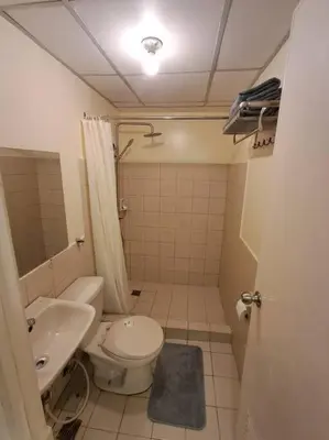 a small bathroom with a toilet and a sink at Cozy Home beside mall,MRTBoniEDSA in Manila