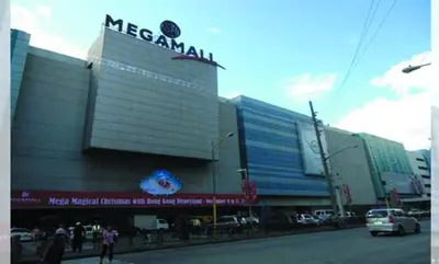 a mexican mall with a sign on the side of a street at Cozy Home beside mall,MRTBoniEDSA in Manila