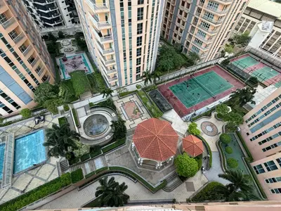 an overhead view of a courtyard in a city with tall buildings at Cozy home Near NAIA & BGC in Manila