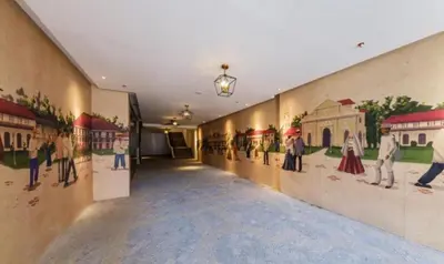 a hallway with paintings on the walls of a building at La Nobleza Manila in Manila