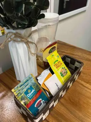 a box of food sitting on a table next to a vase at Condo at the heart of BGC located at Uptown Parksuites in Manila