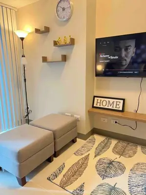 a living room with a couch and a tv at Condo at the heart of BGC located at Uptown Parksuites in Manila