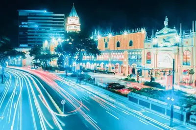 a city street at night with streaks of lights at 10F Luxury 1BR at Park Mckinley West near Venice Mall in Manila