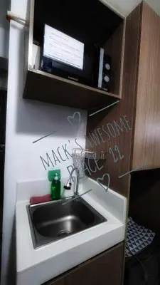 a kitchen sink with writing on the wall above it at Macks Awesome Place 22 Fast Wifi Premium Netflix in Manila