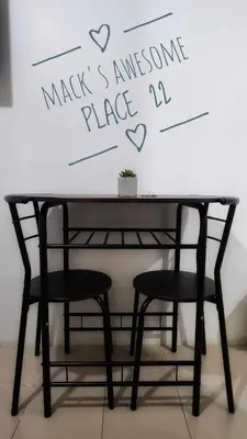 a black table with two chairs in front of a wall at Macks Awesome Place 22 Fast Wifi Premium Netflix in Manila