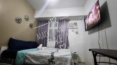a small room with a bed and a tv at Macks Awesome Place 22 Fast Wifi Premium Netflix in Manila