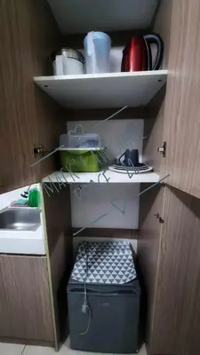 a small kitchen with a sink and a shelf at Macks Awesome Place 22 Fast Wifi Premium Netflix in Manila