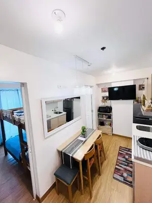 a kitchen and dining room with a table and chairs at Azure Urban Resort Residences in Manila