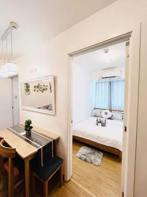 a bedroom with a bed and a table and a desk at Azure Urban Resort Residences in Manila