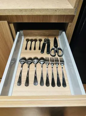 a drawer with spoons and forks and knives at The Hotel at Acqua Residences Tower 2 in Manila