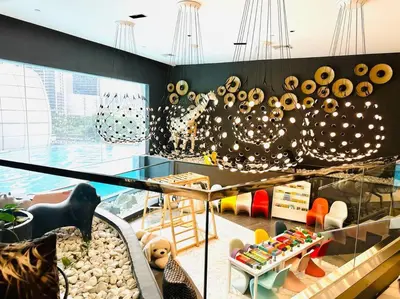 a room with a swimming pool and a display case at The Hotel at Acqua Residences Tower 2 in Manila