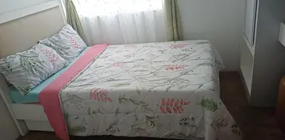 a small bed in a bedroom with a bedspread and pillows at STANFORD SUITES 2 UNIT 755 lilian in Silang