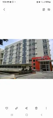 a large building with a red door in front of it at STANFORD SUITES 2 UNIT 755 lilian in Silang