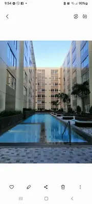 a large swimming pool in front of a building at STANFORD SUITES 2 UNIT 755 lilian in Silang