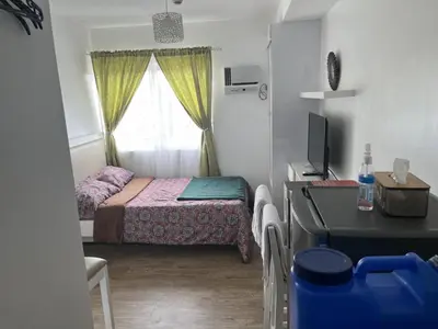a small bedroom with a bed and a window at STANFORD SUITES 2 UNIT 755 lilian in Silang