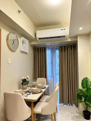 a dining room with a table and chairs at Cozy and Aesthetic Condo at Shore 3 in MOA, Pasay in Manila