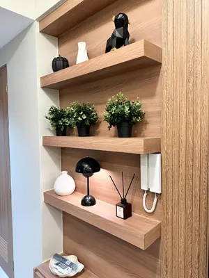 a room with wooden shelves with potted plants at Cozy and Aesthetic Condo at Shore 3 in MOA, Pasay in Manila