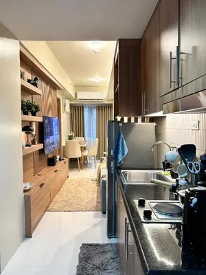 a kitchen with a sink and a refrigerator at Cozy and Aesthetic Condo at Shore 3 in MOA, Pasay in Manila