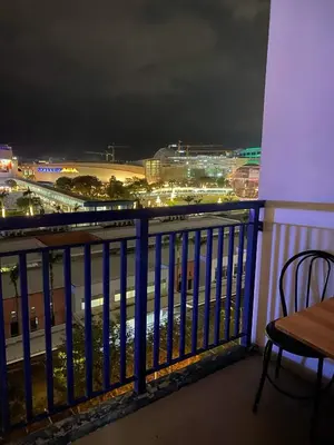 a balcony with a view of a city at night at Sea Residences by-Azenith in Manila