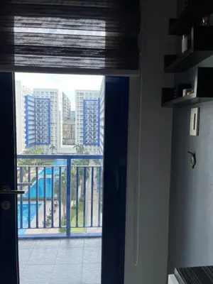 a room with a window with a view of a city at Sea Residences by-Azenith in Manila