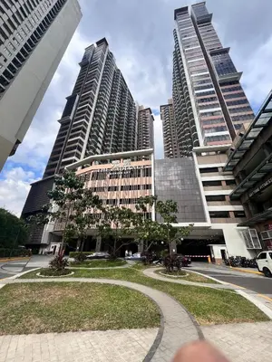 two tall buildings in a city with a park at The RADIANCE MANILA BAY in Manila