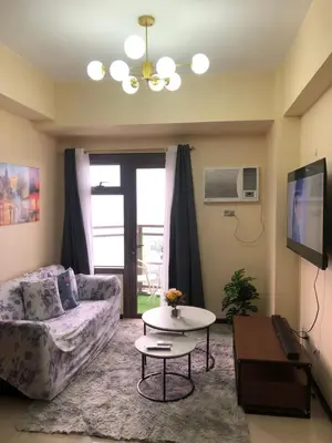 a living room with a couch and a table at The RADIANCE MANILA BAY in Manila