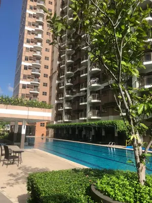 a swimming pool in front of a large apartment building at The RADIANCE MANILA BAY in Manila