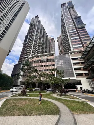 a person walking in front of tall buildings at The RADIANCE MANILA BAY in Manila