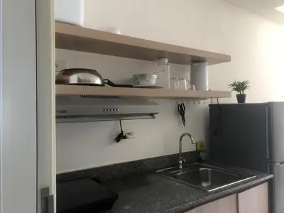 a kitchen with a sink and a refrigerator at SOUTH Residence Condotel in Manila