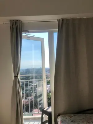 a large window with a view of a city at SOUTH Residence Condotel in Manila