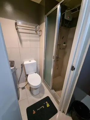 a small bathroom with a toilet and a shower at Shell Residences - 1 br no balcony in Manila