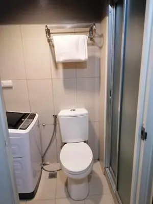 a small bathroom with a toilet and a shower at Shell Residences - 1 br no balcony in Manila