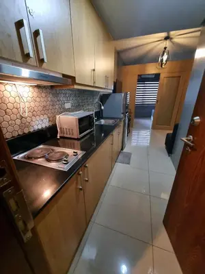 a kitchen with a counter top and a microwave at Shell Residences - 1 br no balcony in Manila