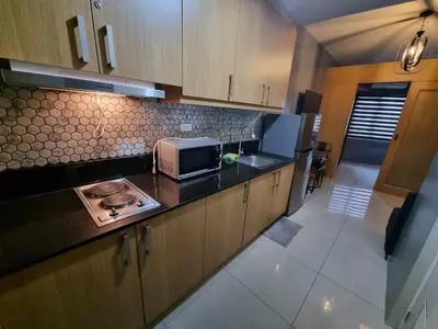 a kitchen with a microwave and a counter top at Shell Residences - 1 br no balcony in Manila