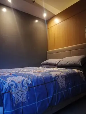 a bedroom with a bed with a blue blanket at Shell Residences - 1 br no balcony in Manila
