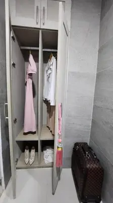 a walk in wardrobe with a pink dress and a suitcase at Coquette vibes close to Cubao's Araneta Center in Manila