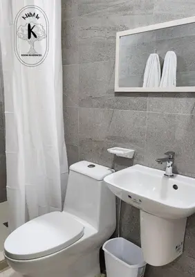 a bathroom with a white toilet and a sink at Coquette vibes close to Cubao's Araneta Center in Manila