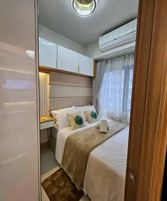 a bedroom with a bed and a window at Cozy apartment near Airport in Shore 3 in Manila